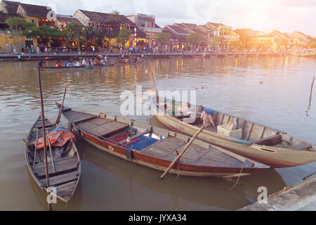 sunset with boats on river in Hoi An Stock Photo