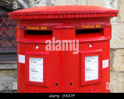 Detail of a traditional red double fronted Royal Mail post box with boxes labelled for “Stamped” and “Franked” mail York  England UK Stock Photo