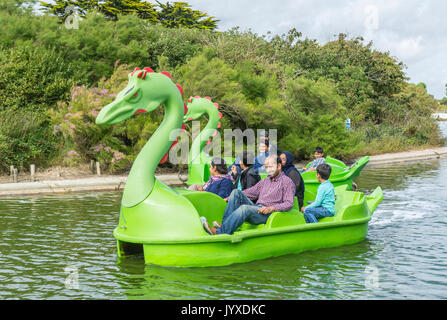 Mewsbrook Park, Littlehampton, West Sussex, England, UK. Sunday 20th August 2017. UK Weather. A family enjoy riding on a pedelo on the boating lake at Mewsbrook Park in Littlehampton this afternoon. The weather is cloudy but fairly warm and dry, near the south coast of England. Credit: Geoff Smith/Alamy Live News Stock Photo