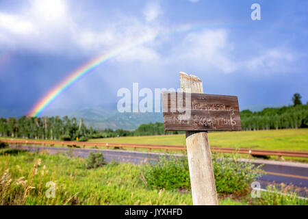 Aspen, Colorado, USA. 9th Aug, 2016. A summer rainbow appears over a ''No Trespassing, No Exceptions'' sign near the Owl Creek Ranch in Aspen, Colorado. Credit: Alex Edelman/ZUMA Wire/Alamy Live News Stock Photo