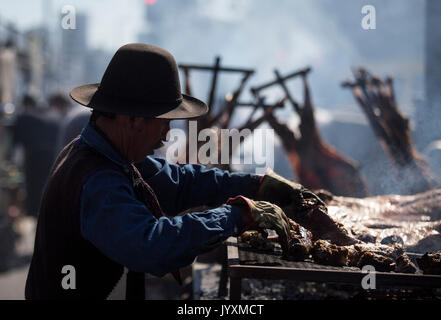 Buenos Aires, Argentina. 20th Aug, 2017. A man prepares meat during a barbecue contest in Buenos Aires, capital of Argentina, on Aug. 20, 2017. 24 couples that represented each Argentinean province and the city of Buenos Aires participated in the contest. Credit: Martin Zabala/Xinhua/Alamy Live News Stock Photo