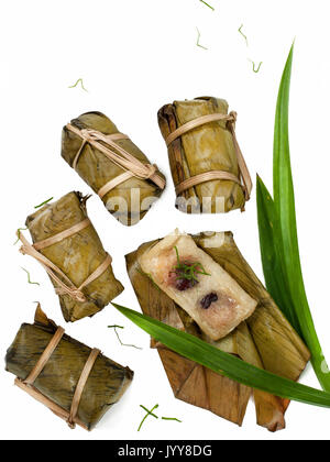 Thai dessert couple of Banana in Sticky Rice and Black Beans Wrapped in Banana leaves Stock Photo