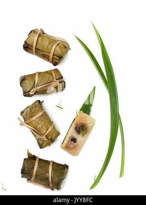 Thai dessert couple of Banana in Sticky Rice and Black Beans Wrapped in Banana leaves Stock Photo