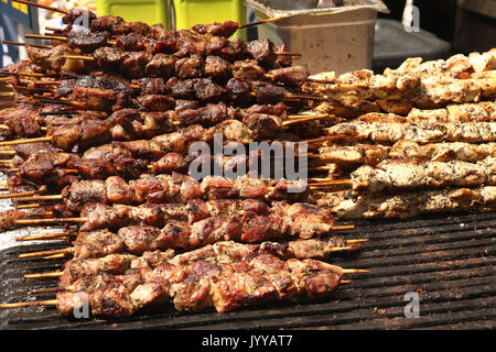 Barbecued skewered beef and chicken shish kebabs on grill Stock Photo