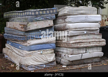 A stack of dirty mattresses are piled up on a roadside in Devon, UK Stock Photo