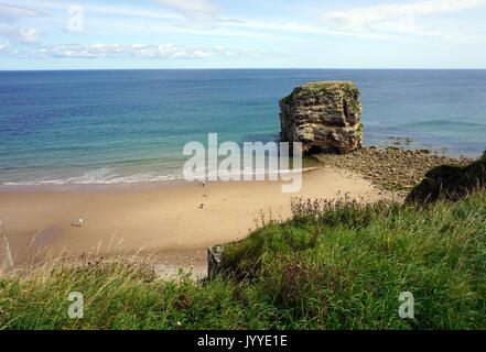 People on the beach at Marsden Rock a Rocky Formation of Limestone  off the North Sea Coast in South Shields England Stock Photo