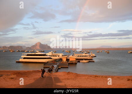 Lake Powell Tour Boats at dock with a rainbow in the background in Page, Arizona, USA Stock Photo