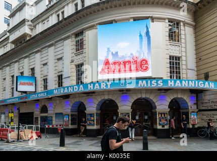 Exterior of the Piccadilly Theatre showing signage for Annie with Miranda Hart as miss Hannigan 16 Denman St, Soho, London W1D 7DY, UK Stock Photo