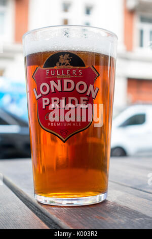 A pint of Fullers London Pride real ale with a little taken out of it English best bitter. Stock Photo