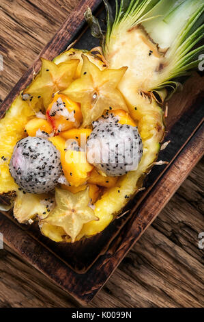 tropic fruits salad in pineapple cut in half Stock Photo