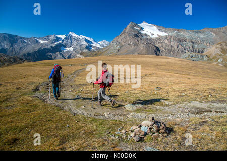 Hikers wallking along Hill of Nivolet. Gran Paradiso national park. Alpi Graie Stock Photo