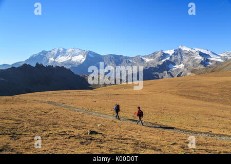 Hikers wallking along Hill of Nivolet. Gran Paradiso national park. Alpi Graie Stock Photo