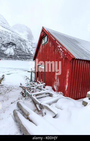 Typical wooden cabin in the snowy landscape of Lyngseidet Lyngen Alps Tromsø Lapland Norway Europe Stock Photo