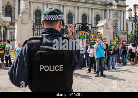 26th June 2010, Belfast. Police officers video and photograph Eirigi members during a demonstration. Stock Photo