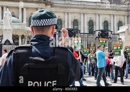 26th June 2010, Belfast. Police officers video and photograph Eirigi members during a demonstration. Stock Photo
