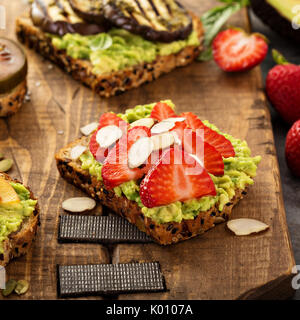 Variety of avocado toasts on a cutting board Stock Photo