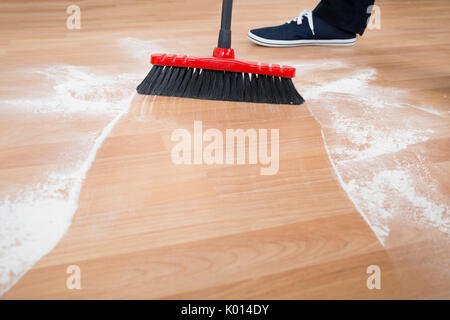 Low section of man sweeping hardwood floor at home Stock Photo