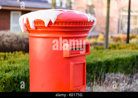 Red post box for children to post letters to Santa Claus. Stock Photo