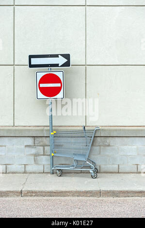 Shopping cart under no entry sign Stock Photo