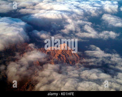 Aerial shot of southern sunlit Grigna emerges from the clouds. Grigna Group. Alps.Lombardy. Italy. Europe. Stock Photo