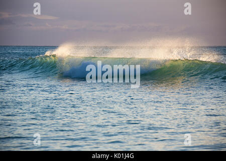 The wave moves toward the beach in the clear waters of the Caribbean Sea Antigua and Barbuda Leeward Island West Indies Stock Photo