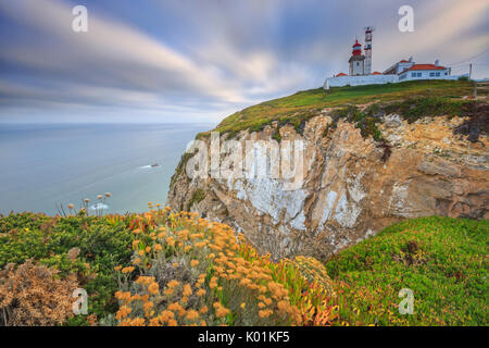 Sunrise on the cape and lighthouse of Cabo da Roca overlooking the Atlantic Ocean Sintra Portugal Europe Stock Photo