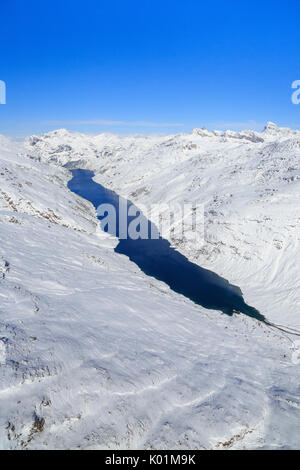 Aerial view of the alpine Lago di Lei surrounded by snow Val di Lei Chiavenna Spluga Valley Valtellina Lombardy Italy Europe Stock Photo