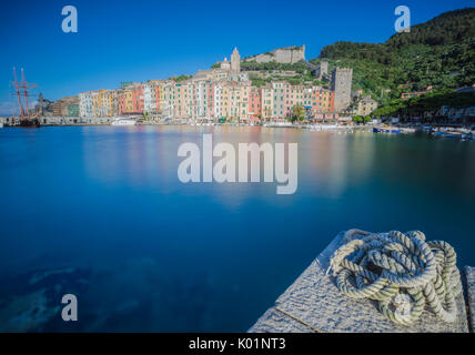 View of blue sea surrounding the colorful village at dusk Portovenere province of La Spezia Liguria Italy Europe Stock Photo