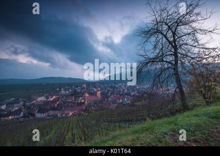 Clouds on the old town of Riquewihr surrounded by green vineyards  Haut-Rhin department Grand Est Alsace France Europe Stock Photo