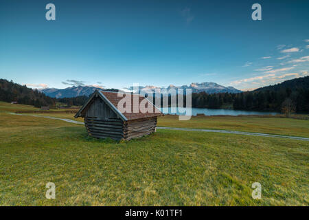 Wooden hut frames the alpine lake surrounded by the Alps Geroldsee Krün Garmisch Partenkirchen Upper Bavaria Germany Europe Stock Photo