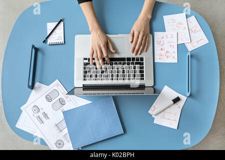 Girl using laptop in office Stock Photo