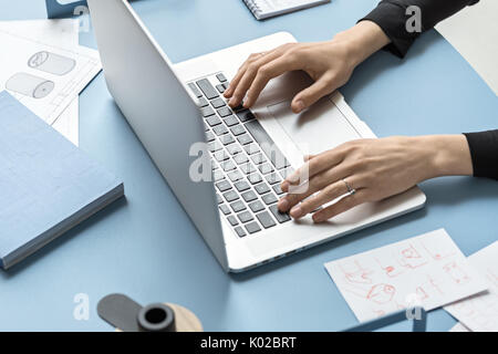 Woman using laptop in office Stock Photo