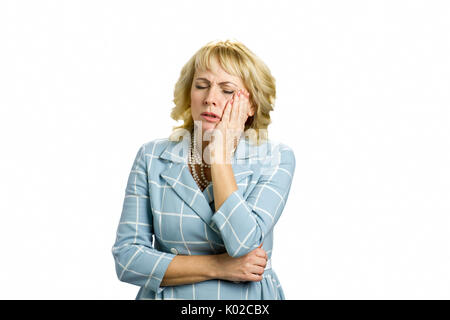 Unhappy white-skin woman suffering toothache. Beautiful middle aged woman suffering from terrible strong teeth pain, touching cheek with closed eyes s Stock Photo