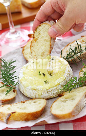 baked camembert cheese fondue with bread Stock Photo
