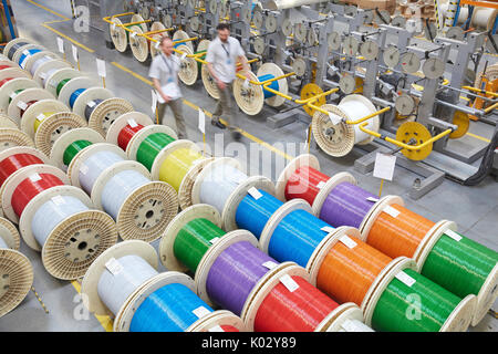 Elevated view multicolor spools in fiber optics factory Stock Photo