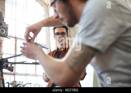 Male designers assembling drone in workshop Stock Photo