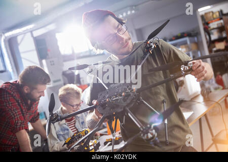 Male designer assembling drone in workshop Stock Photo