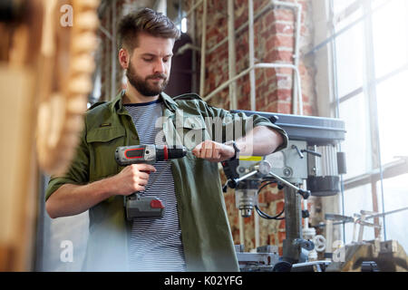 Designer using power drill in workshop Stock Photo
