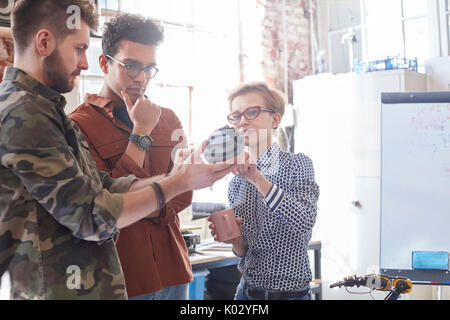 Designers meeting, examining prototype in workshop Stock Photo