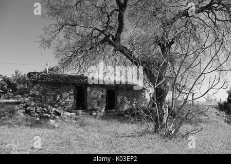 Black and white photo of old rural stone house Stock Photo