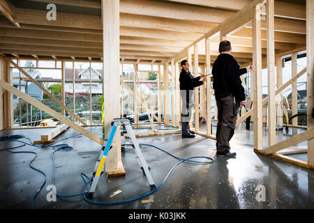 Male Carpenters Working At Construction Site Stock Photo