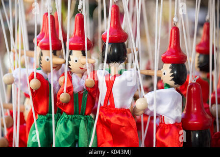 Traditional painted red and green wooden Pinocchio marionette dolls, Italy Stock Photo