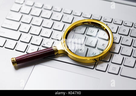 information search on internet concept. magnifying glass on the keyboard Stock Photo