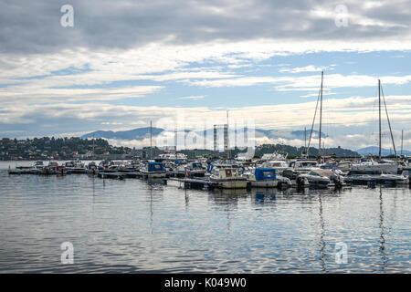 View of the marina in the town of Leirvik, Norway, in the background overcast sky over the fjords. Stock Photo