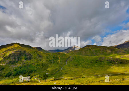 Snowdonia, Wales August 2017.  Mountain view captured in light HDR. Snowdon mountain area with roads and houses nearby covered in summer light weather Stock Photo