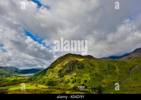 Snowdonia, Wales August 2017.  Mountain view captured in light HDR. Snowdon mountain area with roads and houses nearby covered in summer light weather Stock Photo