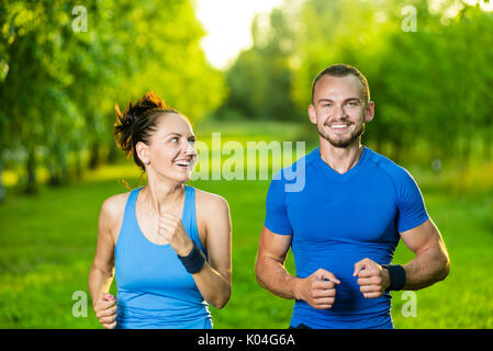 Runners training outdoors working out. City running couple jogging outside.  Stock Photo