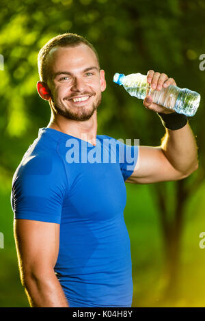 Athletic mature man drinking water from a bottle Stock Photo