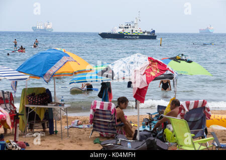 After the recent terrorist incidents, a police patrol boat cruises past the beaches of Gibraltar to reassure the tourists Stock Photo