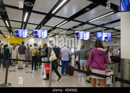 People at the UK border at Gatwick airport waiting to go through the epassport gates to check passport details.The system uses iris recognition. Stock Photo